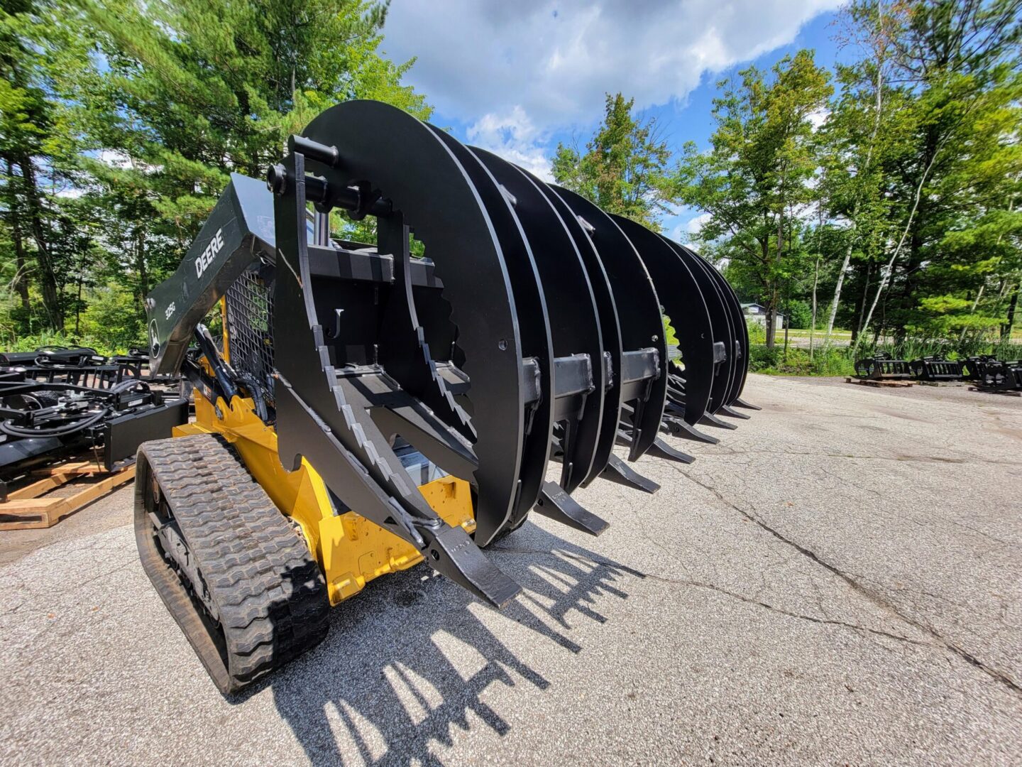 A large yellow and black machine is parked in the street