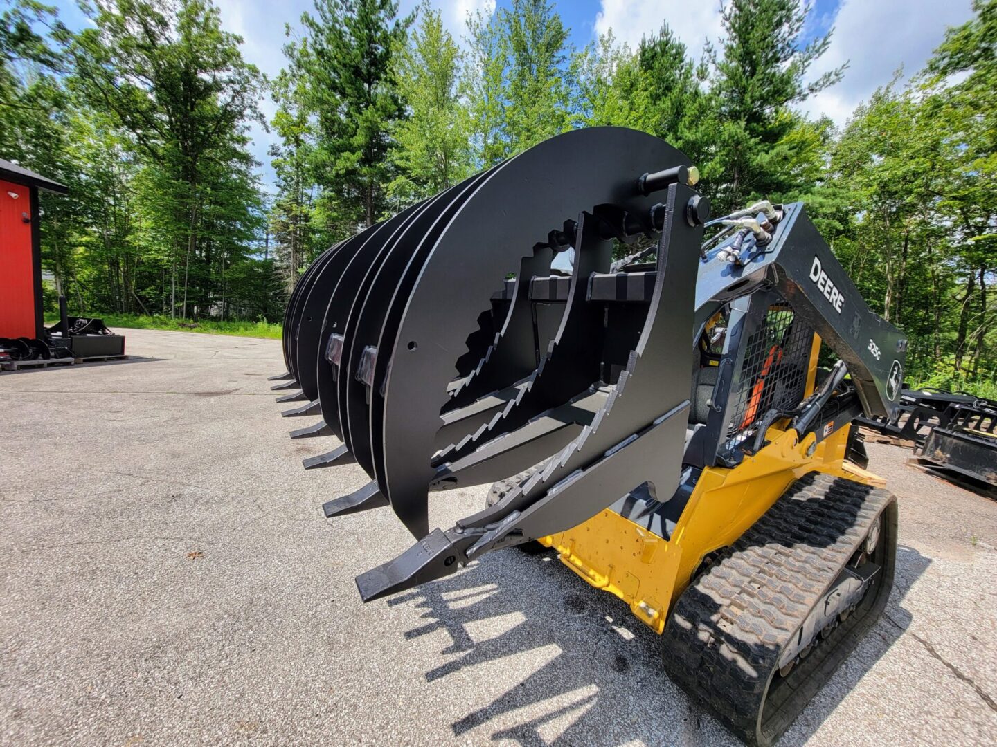 A row of large black metal machinery in the middle of a parking lot.