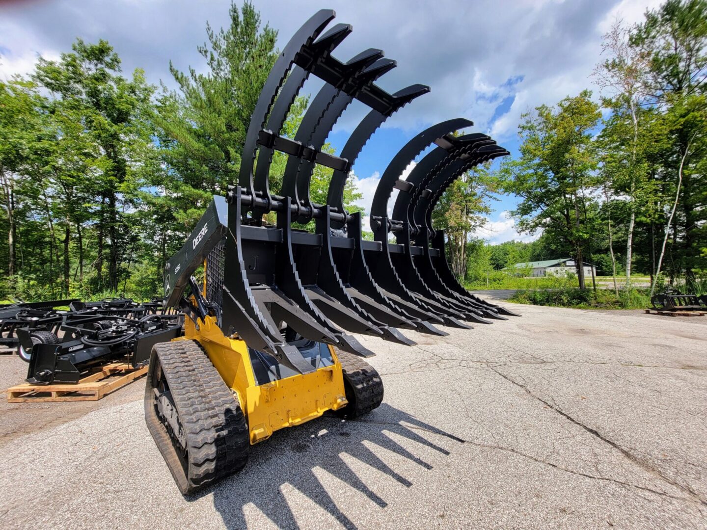 A yellow and black tractor with large forks on it