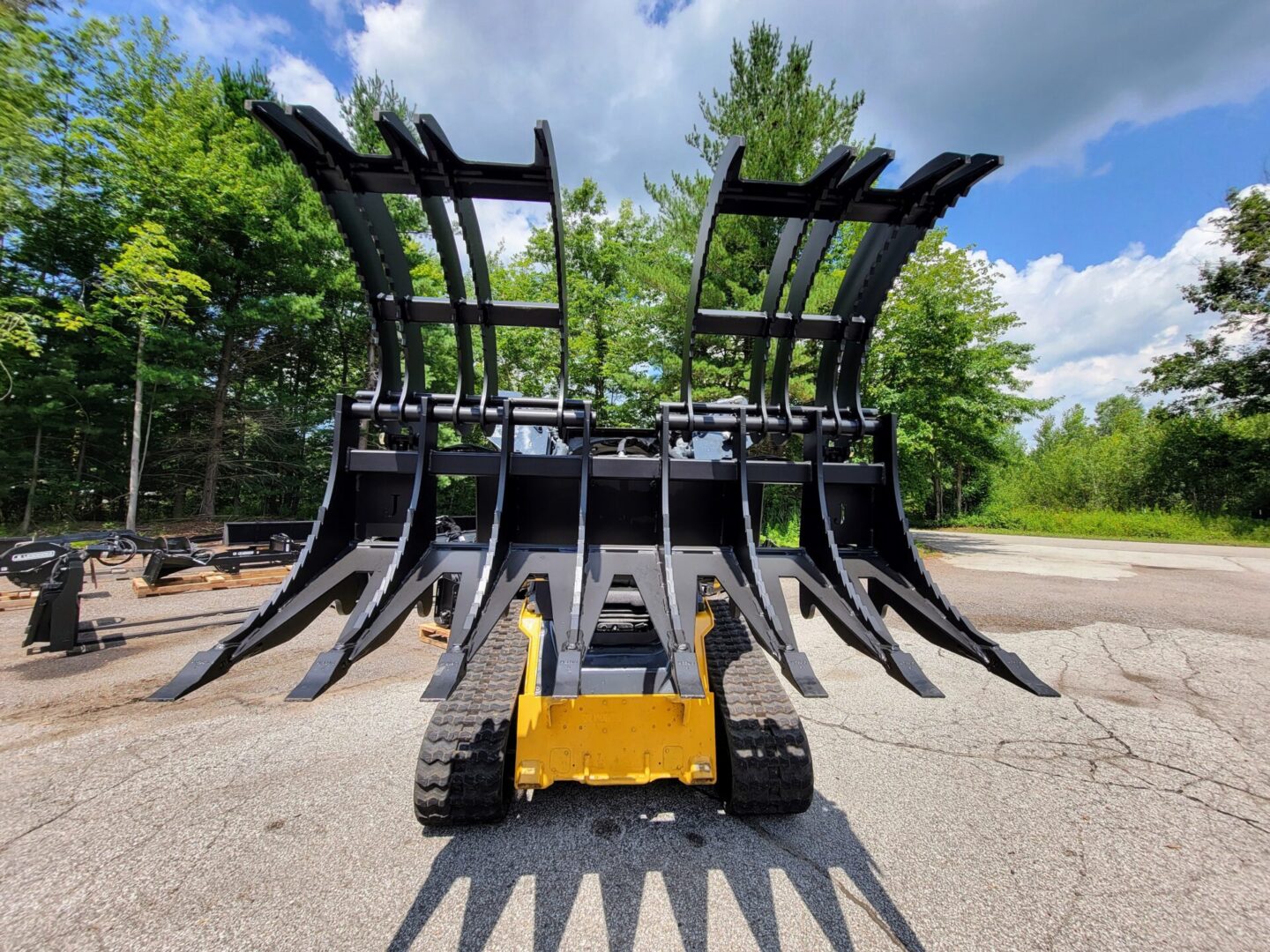 A large yellow and black machine in the middle of a road.