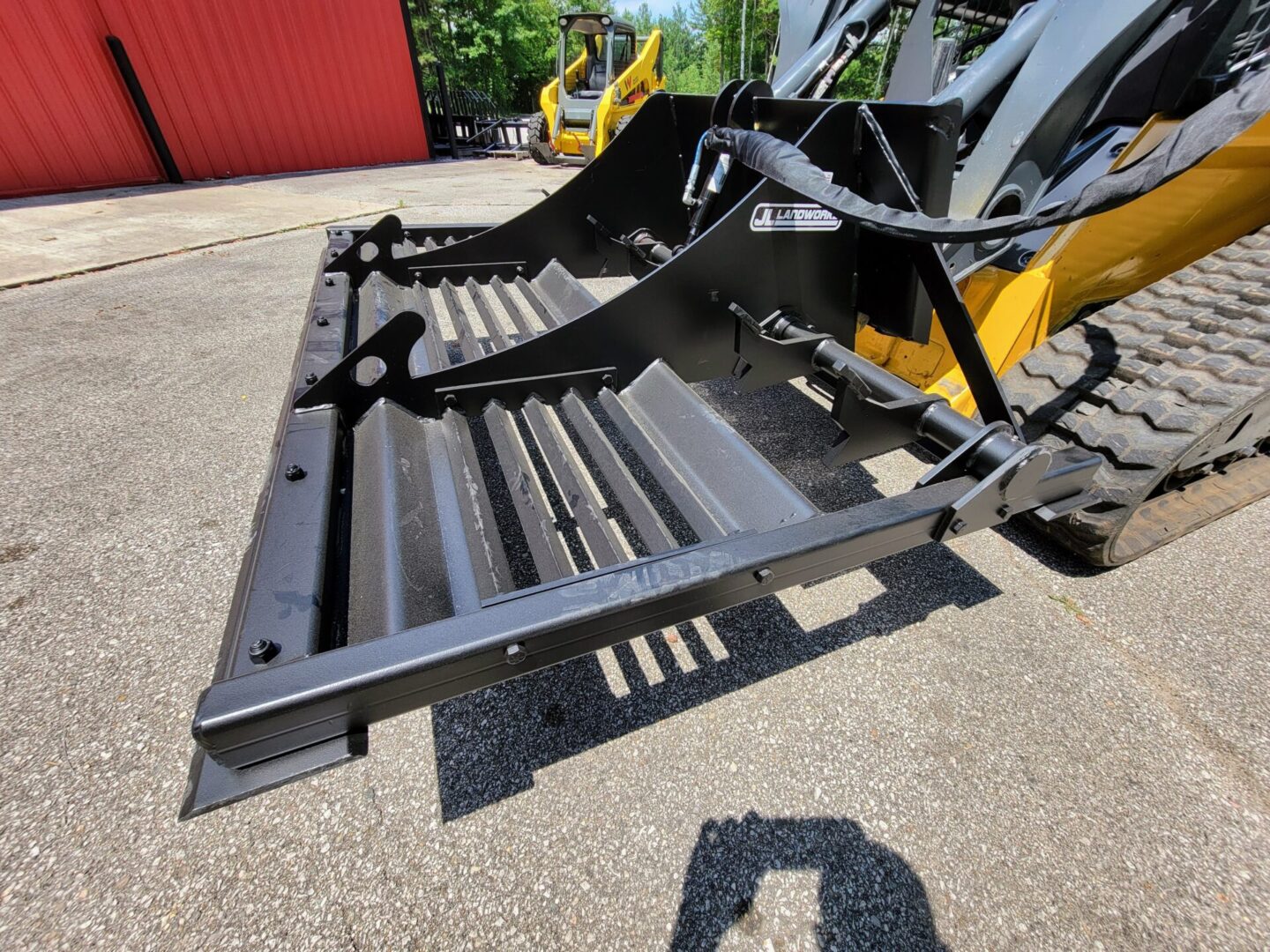 A close up of the back end of a yellow and black tractor.