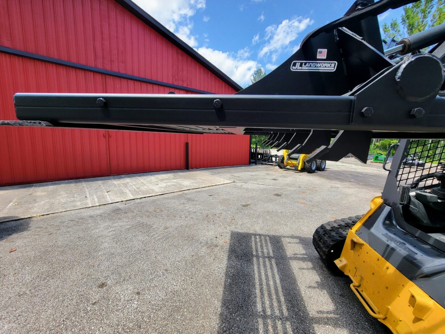 A yellow and black truck parked in front of a red building.