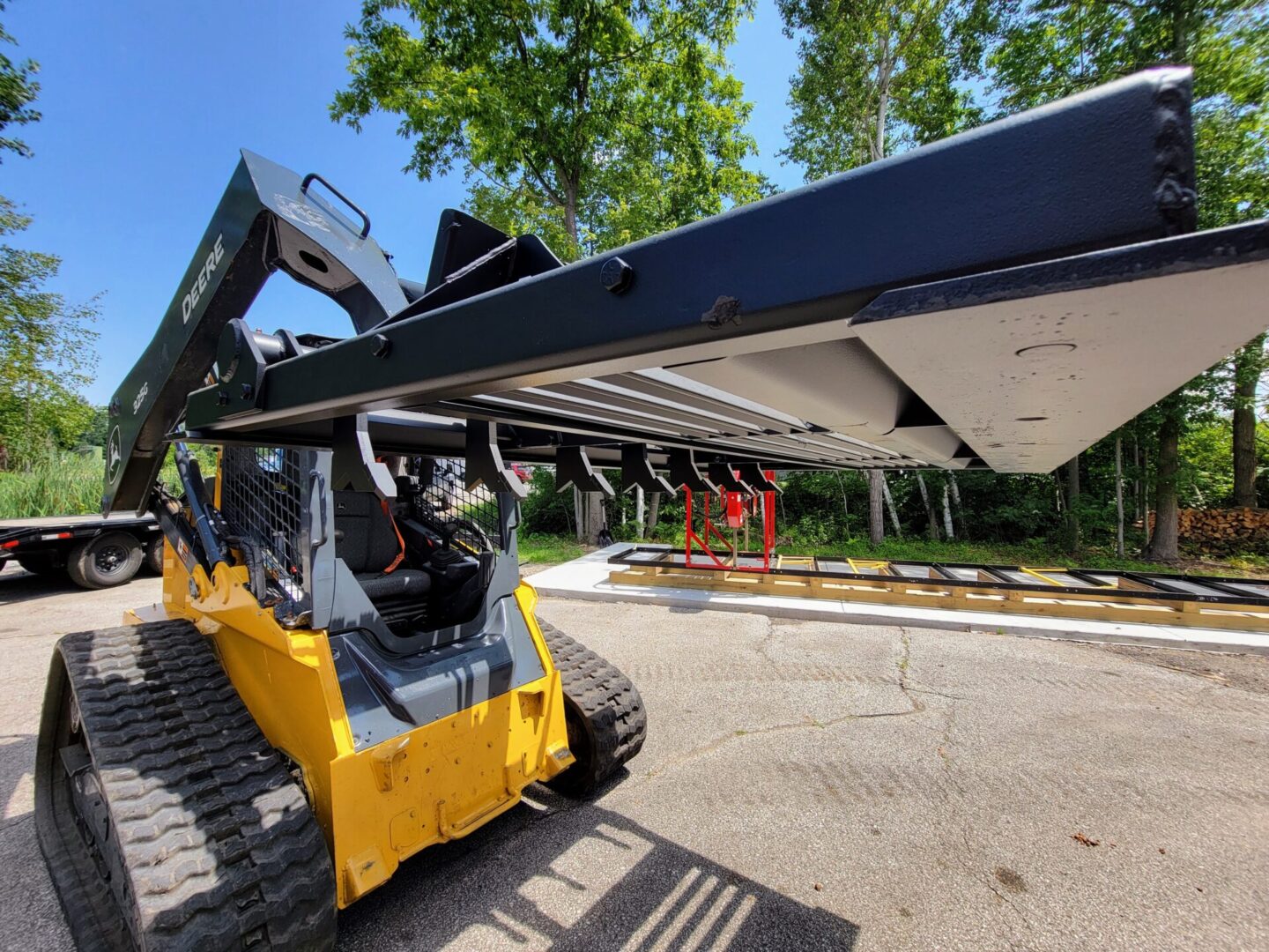 A large yellow and black construction vehicle parked in the street.