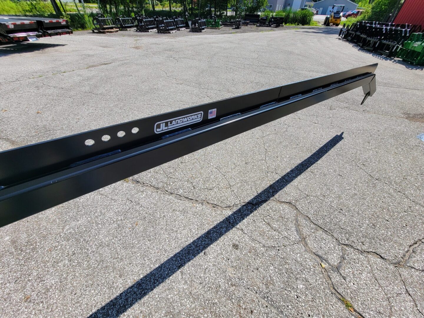 A black metal pole sitting on top of a concrete ground.