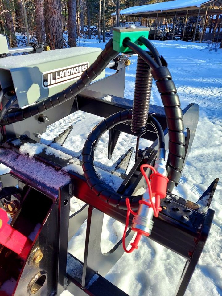 A close up of the plow attachment on a tractor.