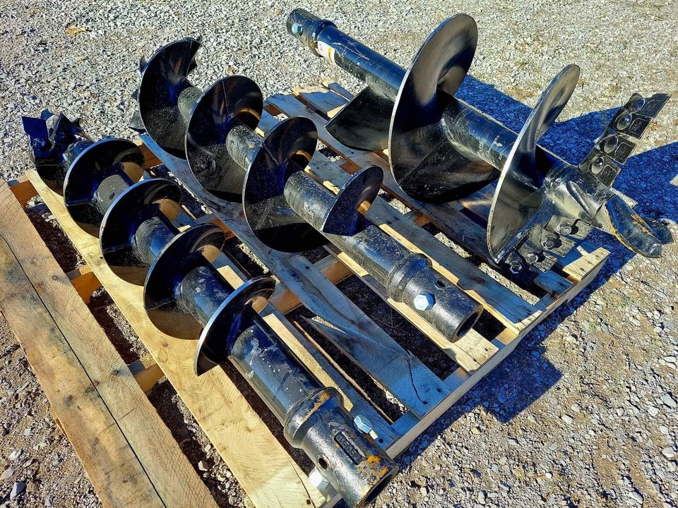 A pallet of metal parts sitting on top of the ground.