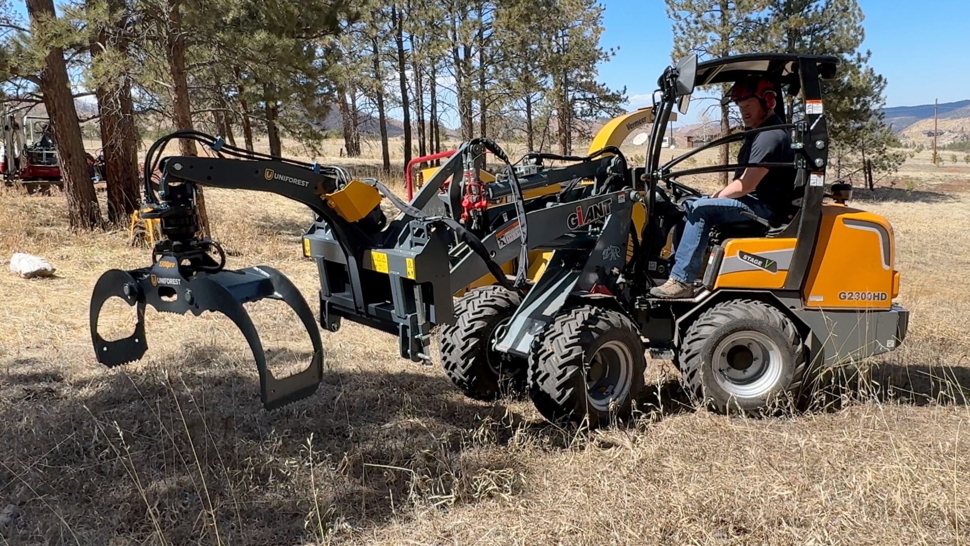 A man riding on the back of a small tractor.