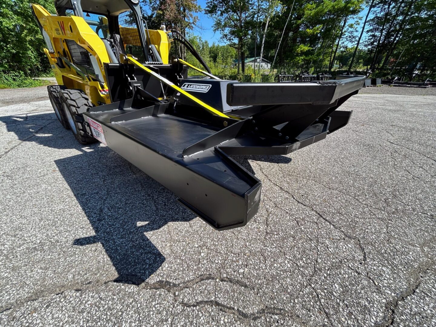 A yellow and black tractor is parked on the street