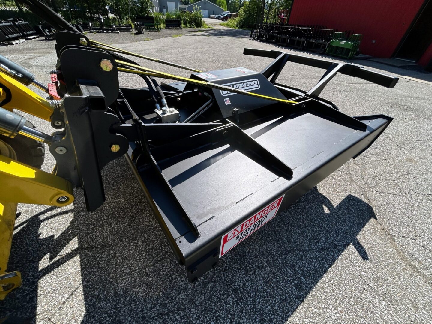 A black and yellow trailer has two large pieces of metal.