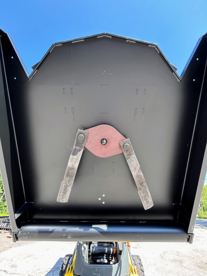 A view of the back of an oven with a pink handle.