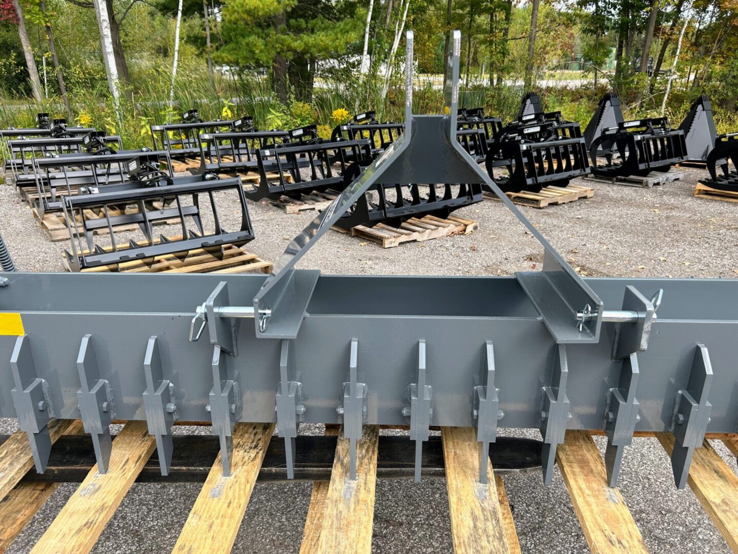 A large metal plow sitting on top of a field.