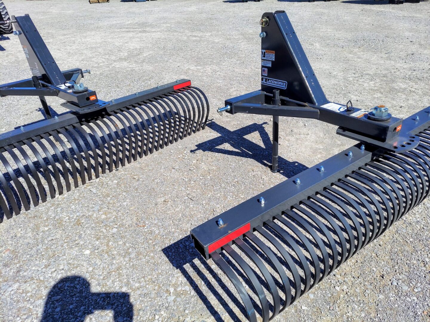 A pair of attachments for a tractor rake.