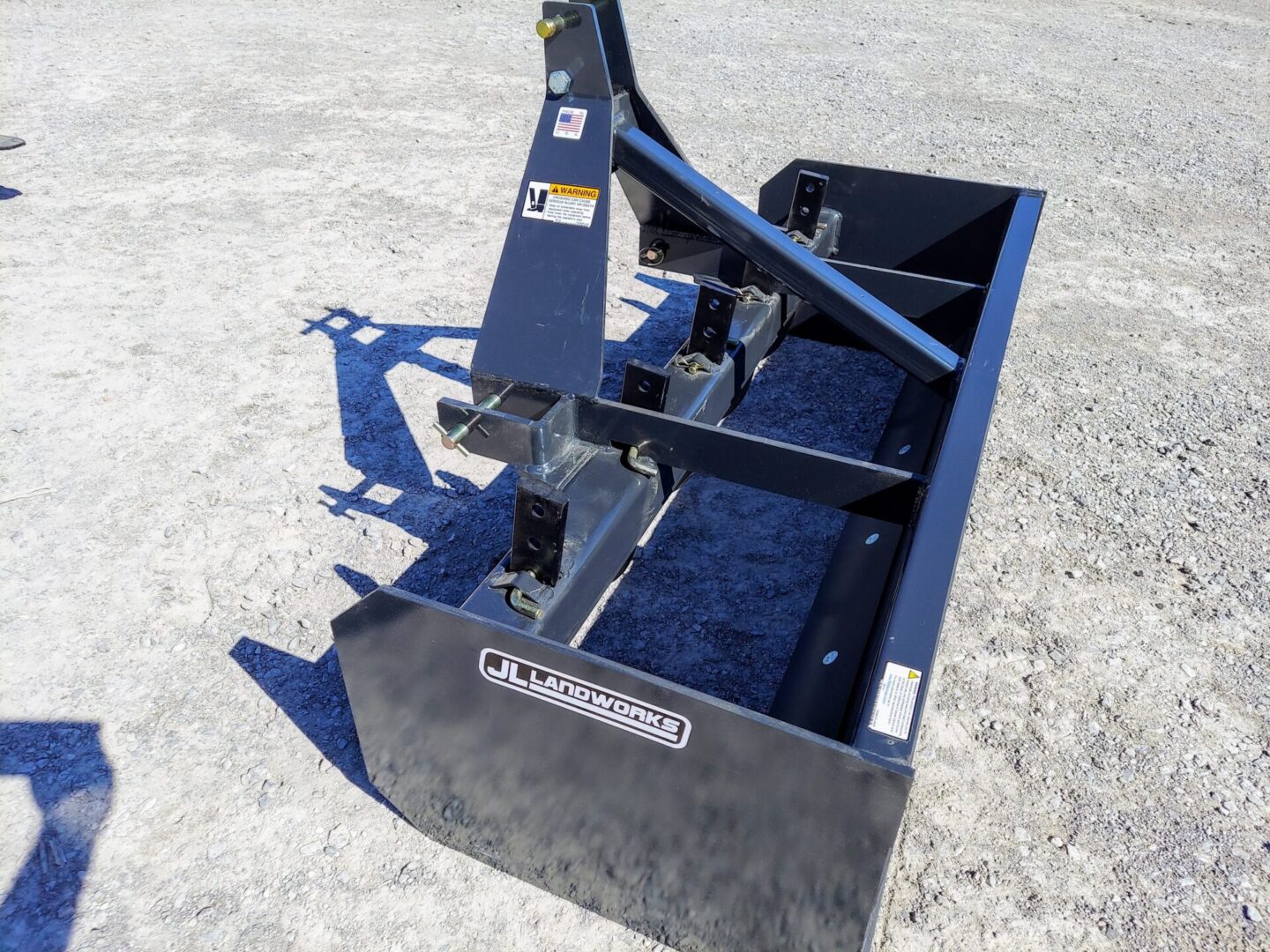 A blue box with a plow attached to it