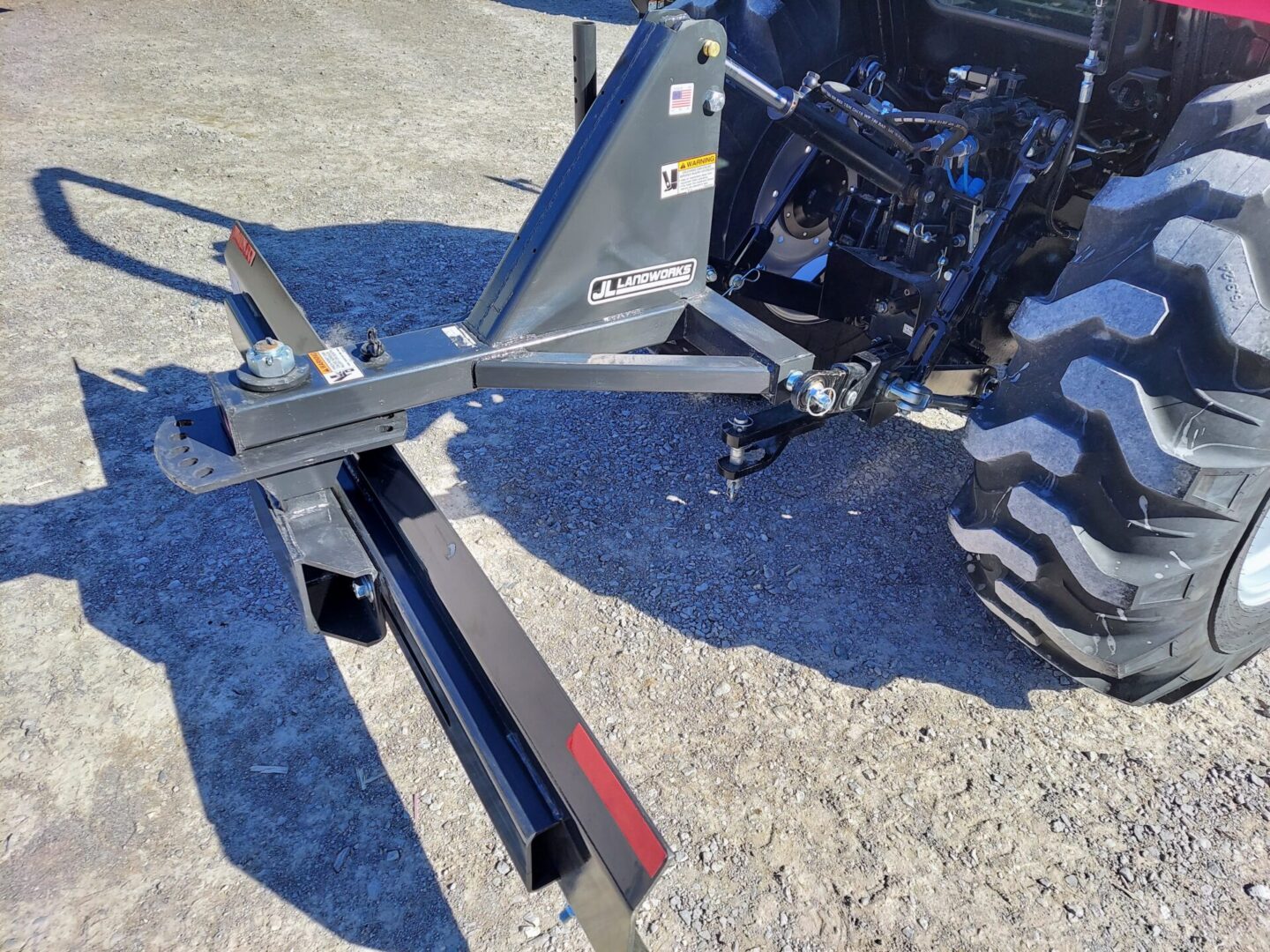 A tractor with a plow attachment attached to it.