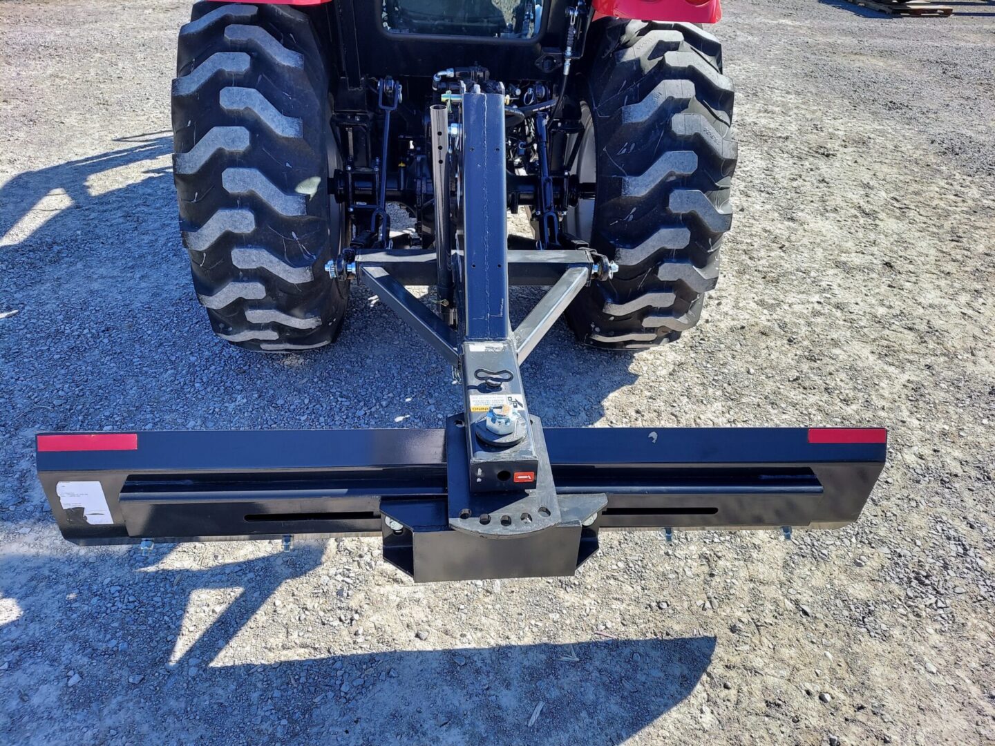 A tractor with a plow attachment attached to it.