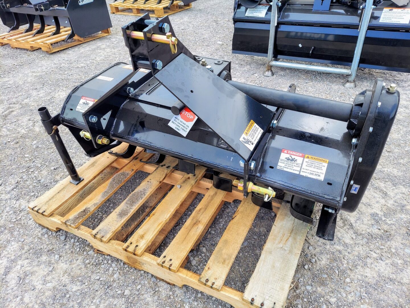 A pallet of pallets with a tractor mounted attachment.