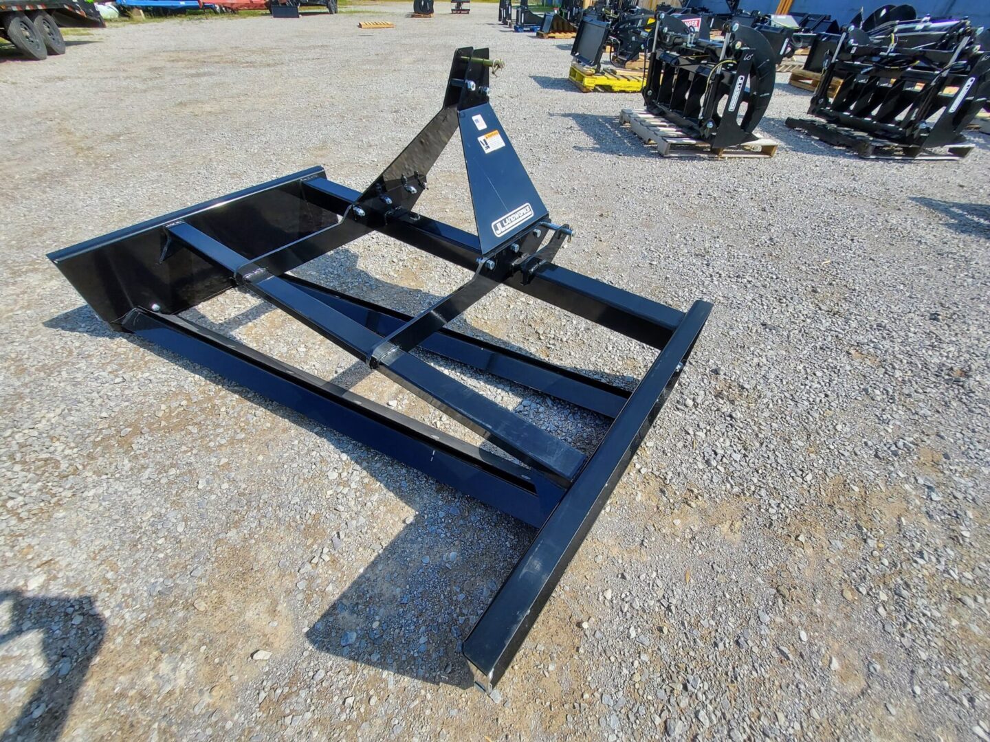 A black metal frame sitting on top of a gravel ground.