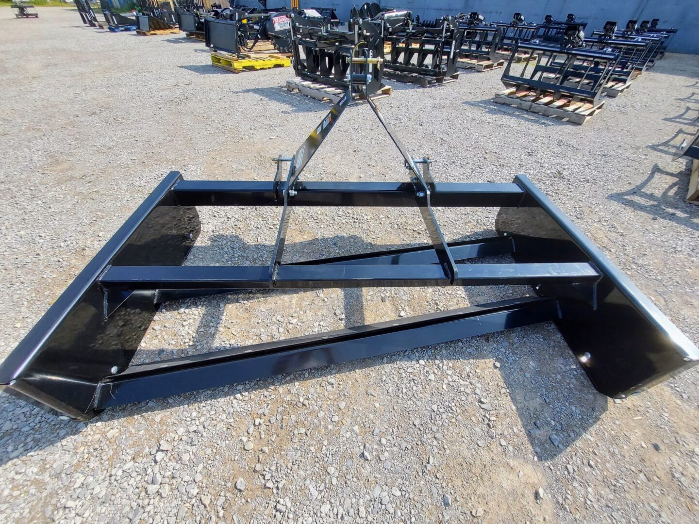 A black metal frame sitting on top of a gravel ground.