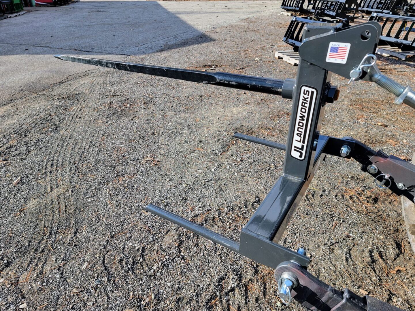 A close up of the front end of a tractor with a fork.