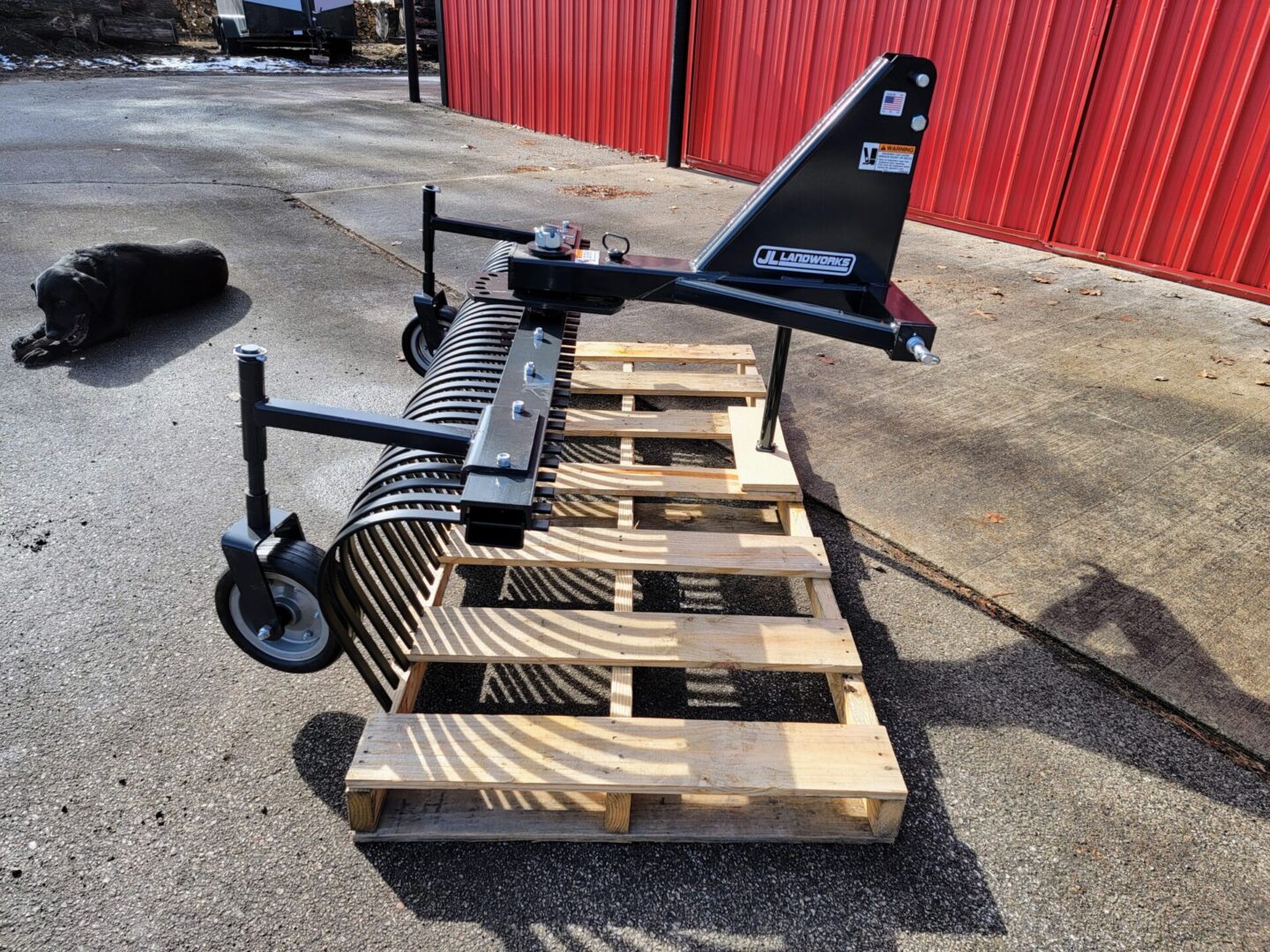 A pallet with some wooden pallets and a black plow