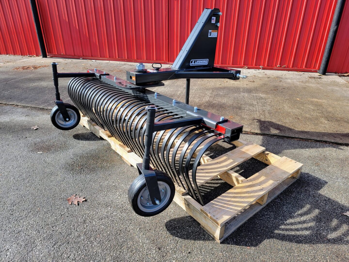 A large metal pipe sitting on top of a wooden pallet.