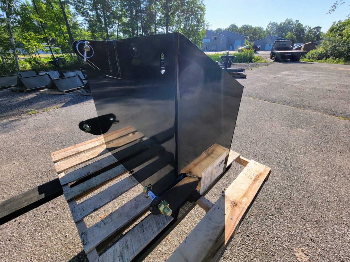 A black metal box sitting on top of wooden pallets.