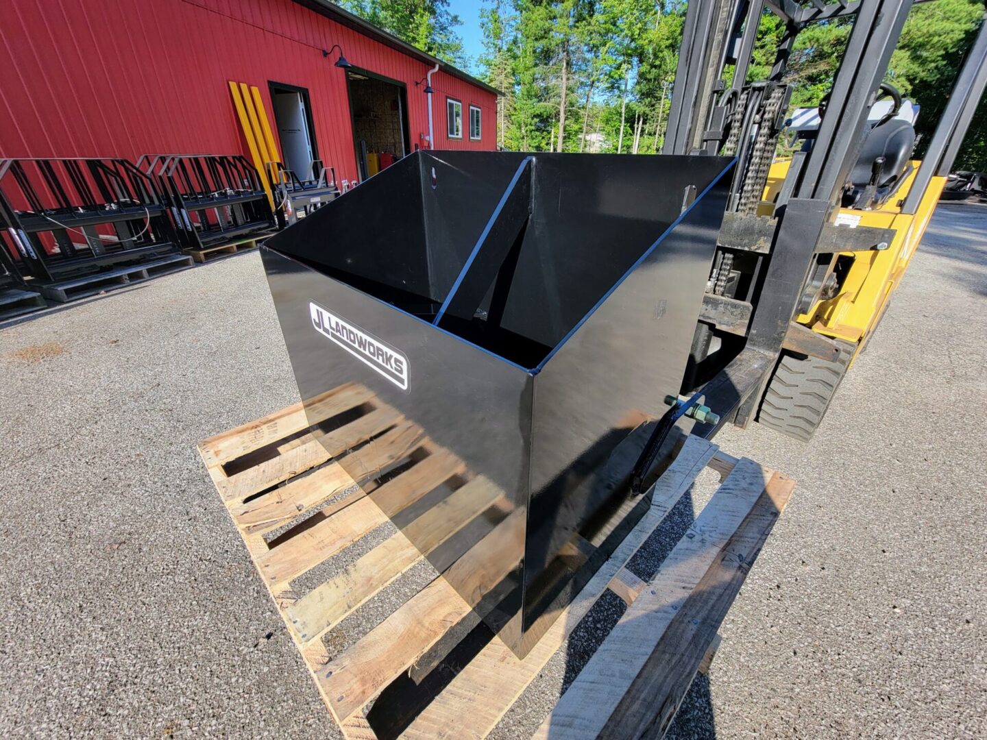 A black box sitting on top of a wooden pallet.