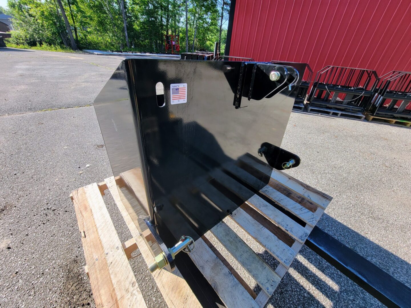 A black metal box sitting on top of a wooden pallet.