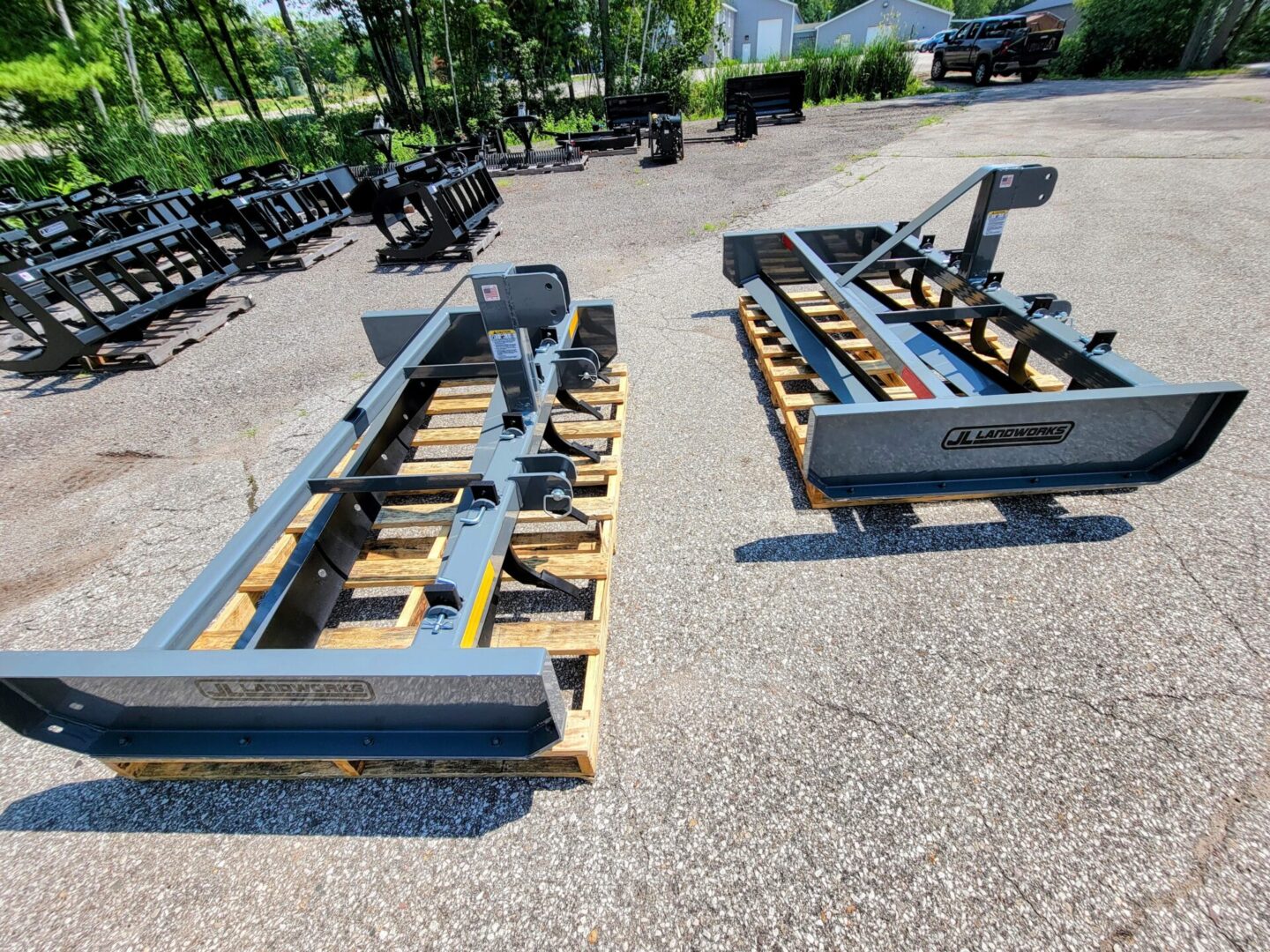 Two large metal frames sitting on top of a gravel ground.